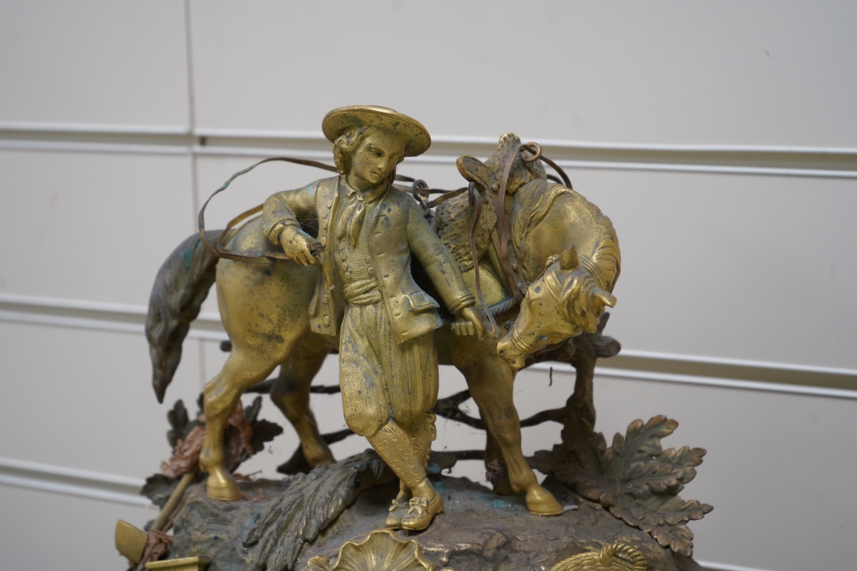 A 19th century French gilt spelter clock surmounted with a horse and rider, 39cm high